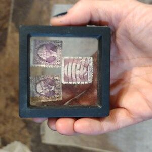 2 $15,000 3 cent Washington stamps an one $10000 value Eisenhower 8 cent stamp